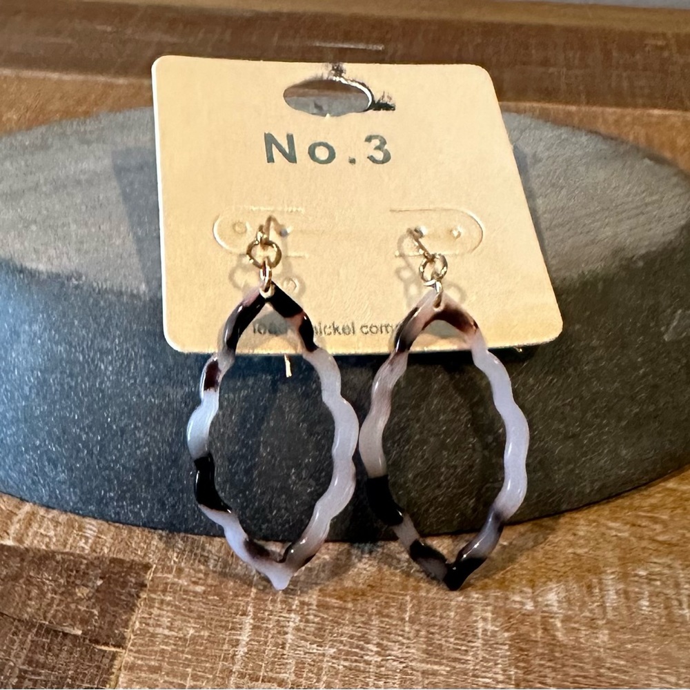 New earrings with a brown swirl throughout.